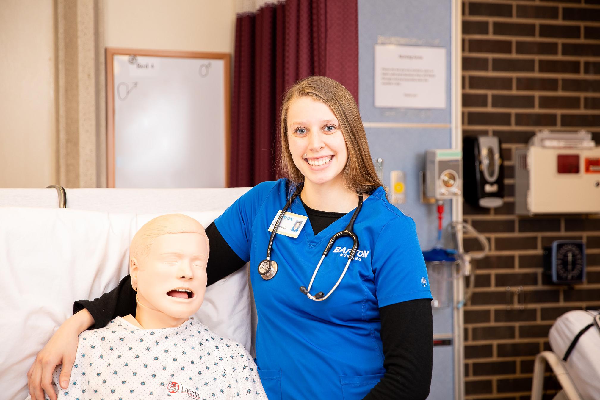 nurse posing with a mannequin