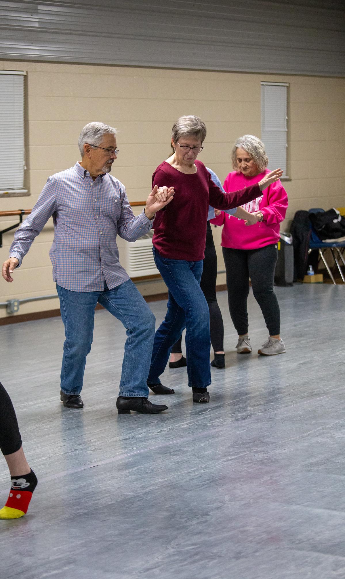 two people dancing together hand in hand