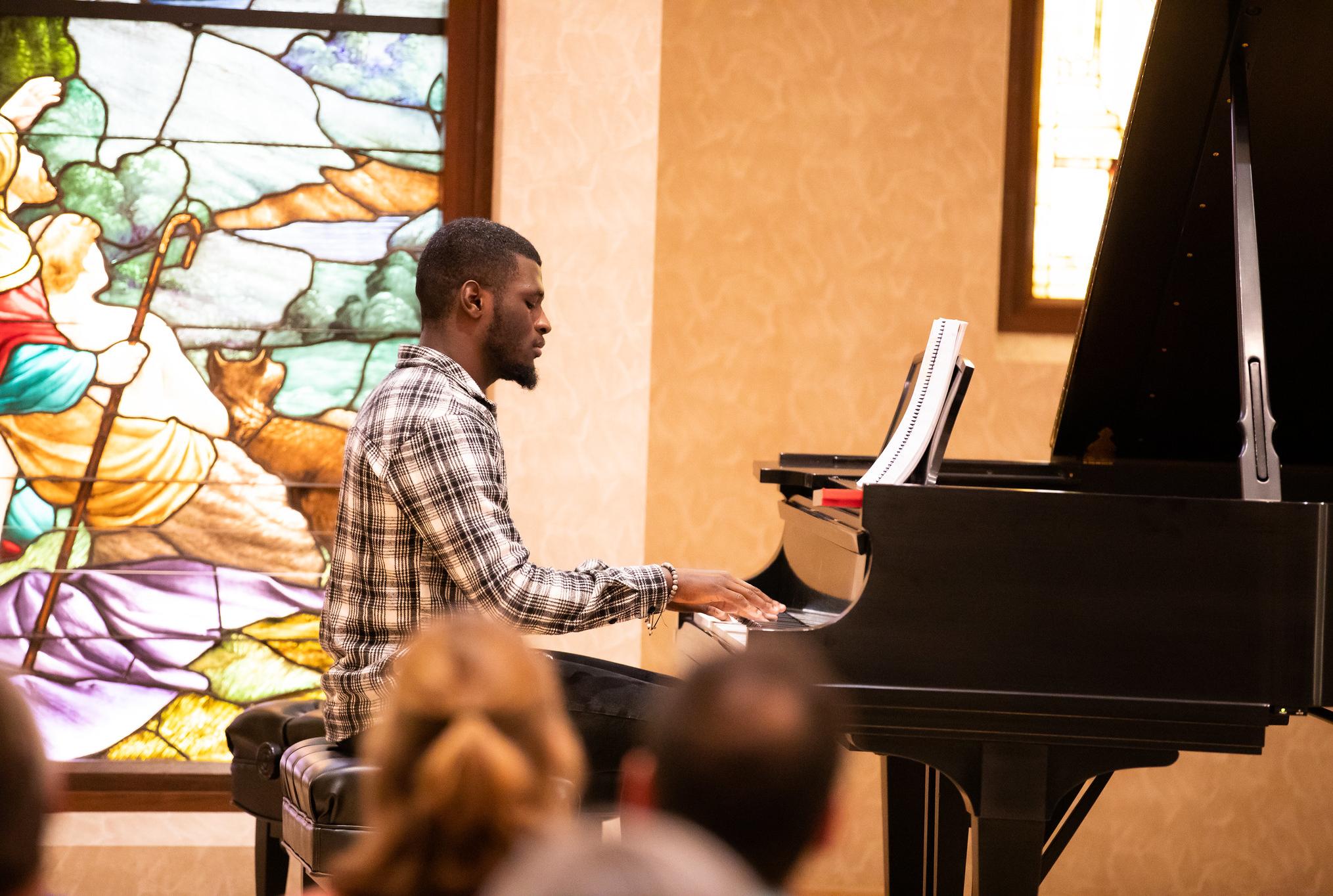 student playing piano at a recital