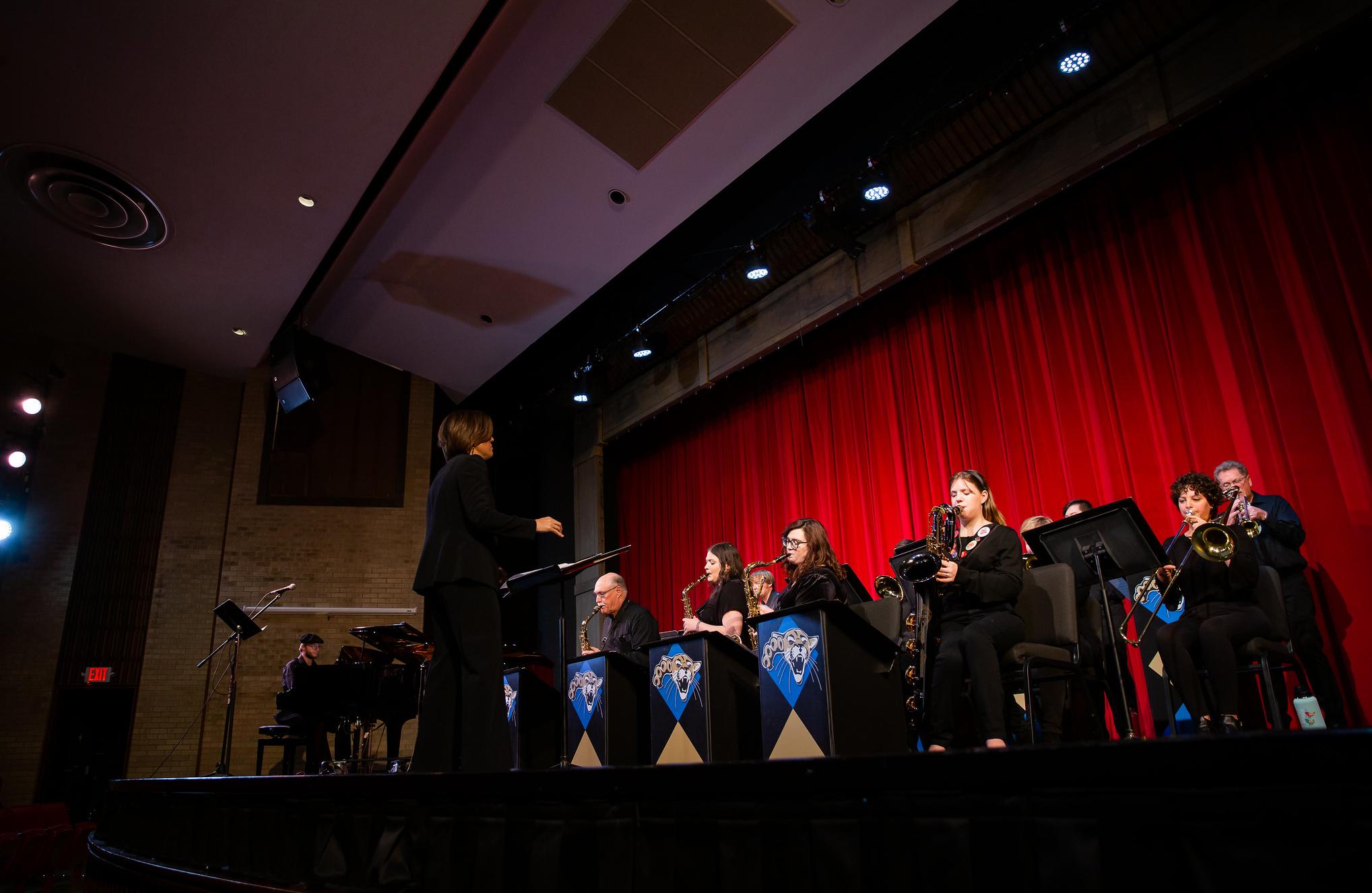 musicians performing in front of a red curtain