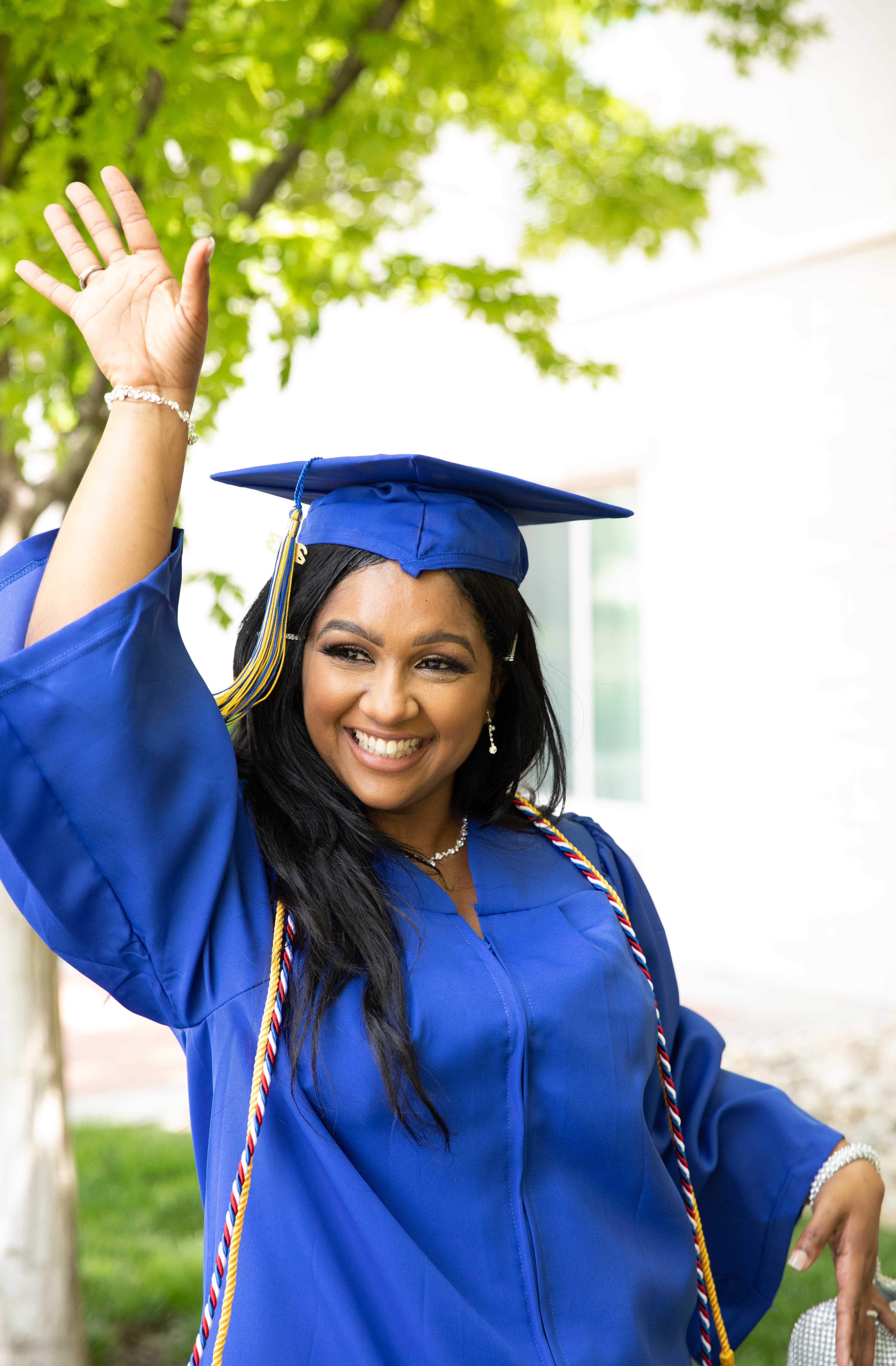 graduate smiling in cap and gown