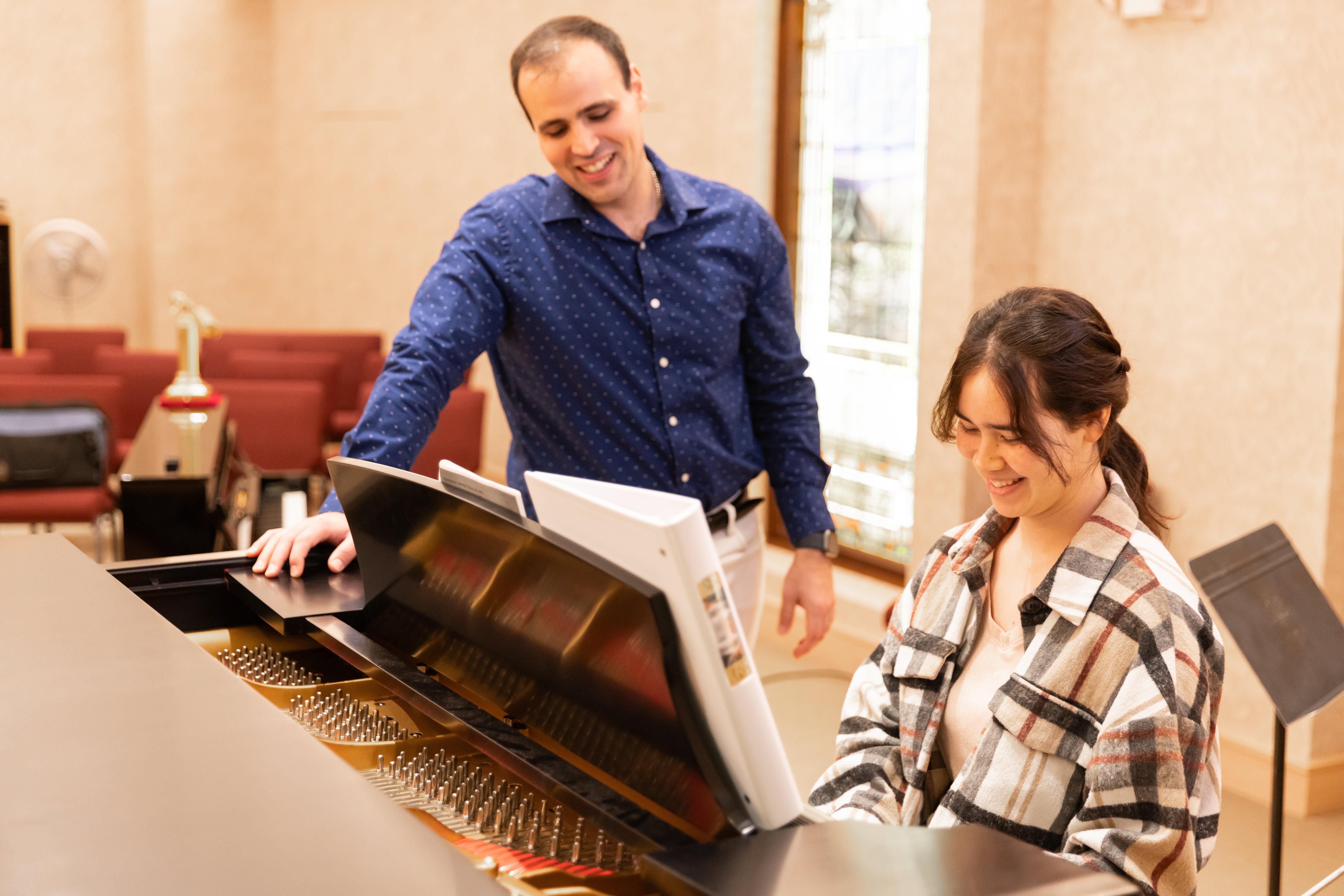 A Barton student receives instruction on the piano from Dr. Avila as a part of the music accompaniment program. 